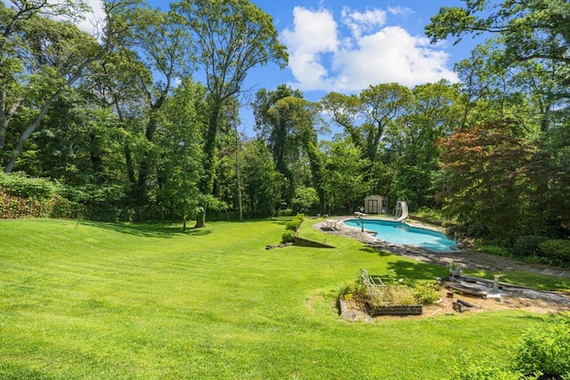 10 Faulkner Ln, Dix Hills, NY 11746 - view of pool with a water slide, a storage unit, and a yard
