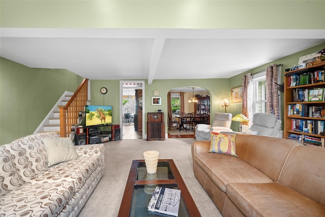 27 Neulist Ave, Port Washington, NY 11050 - living area with arched walkways, carpet floors, stairs, and beamed ceiling