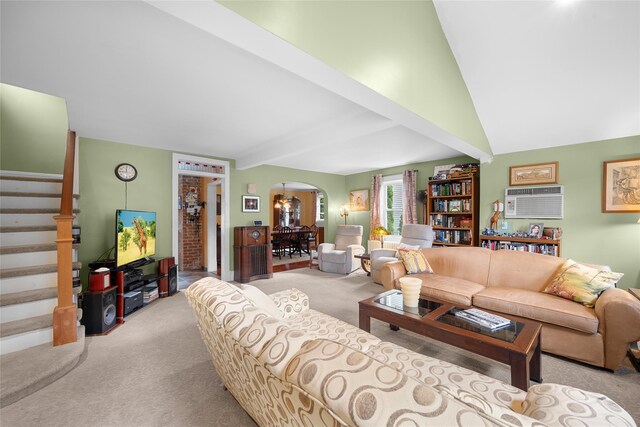 27 Neulist Ave, Port Washington, NY 11050 - living room with carpet flooring, arched walkways, stairs, a wall unit AC, and vaulted ceiling