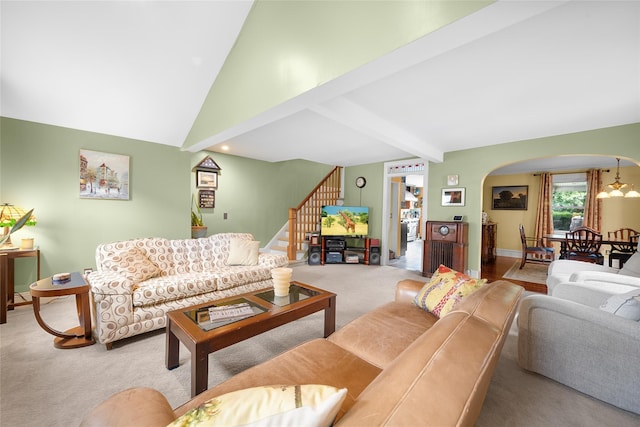 27 Neulist Ave, Port Washington, NY 11050 - living area featuring arched walkways, vaulted ceiling, carpet floors, and stairway