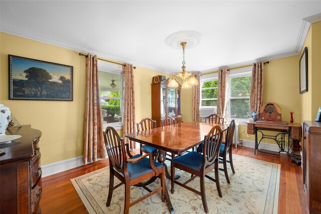27 Neulist Ave, Port Washington, NY 11050 - dining room with ornamental molding, wood finished floors, and a chandelier