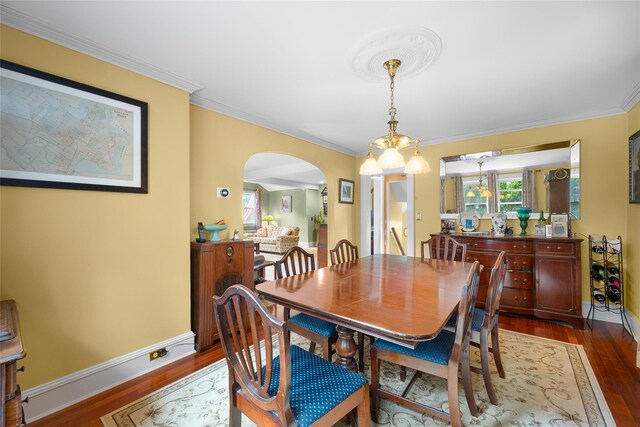 27 Neulist Ave, Port Washington, NY 11050 - dining space with arched walkways, wood finished floors, and ornamental molding
