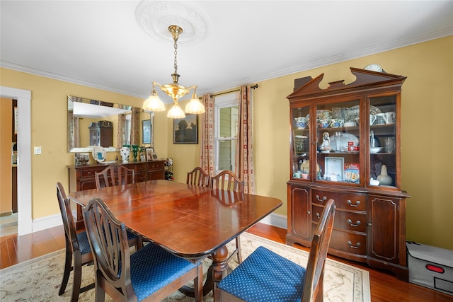 27 Neulist Ave, Port Washington, NY 11050 - dining space featuring a chandelier, crown molding, and wood finished floors