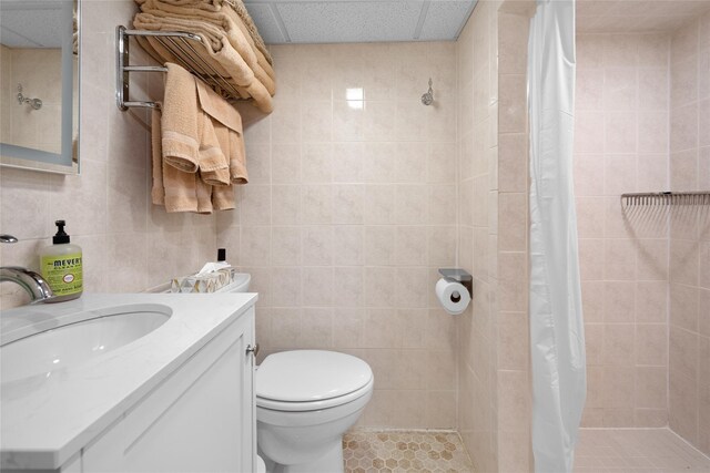 27 Neulist Ave, Port Washington, NY 11050 - full bathroom featuring tiled shower, vanity, and tile walls