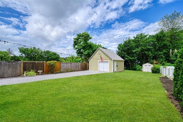 27 Neulist Ave, Port Washington, NY 11050 - fenced yard featuring a shed, a garage, and gravel driveway