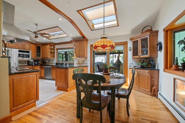 713 Thomas Ave, Baldwin, NY 11510 - dining space featuring baseboard heating, a skylight, light wood-style floors, a ceiling fan, and recessed lighting