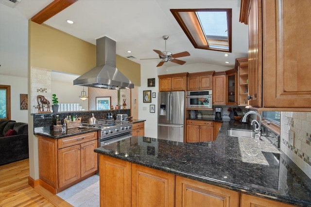 713 Thomas Ave, Baldwin, NY 11510 - kitchen with stainless steel appliances, island range hood, a peninsula, decorative backsplash, and brown cabinetry