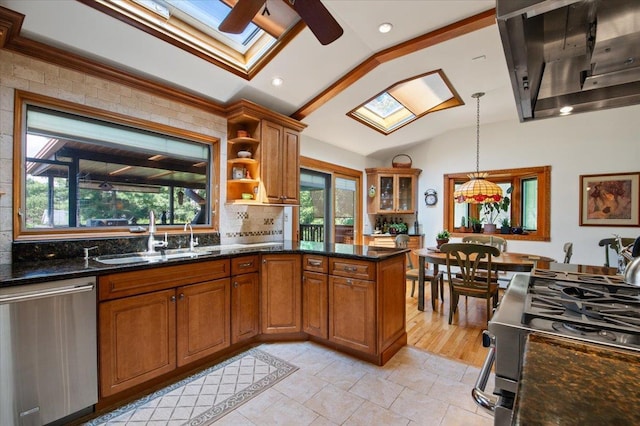 713 Thomas Ave, Baldwin, NY 11510 - kitchen with appliances with stainless steel finishes, a skylight, lofted ceiling, ventilation hood, and brown cabinetry