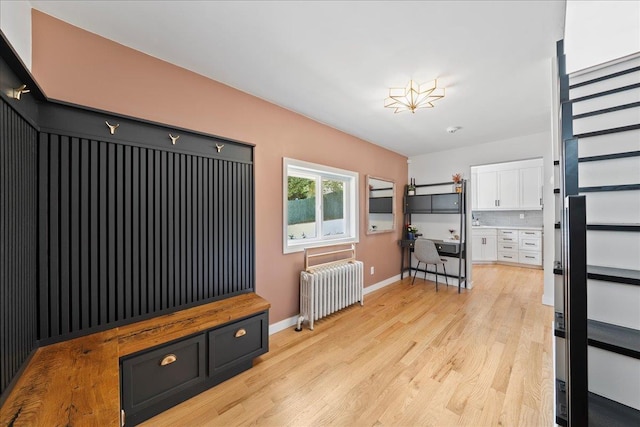 56 Summers St, Oyster Bay, NY 11771 - unfurnished living room with radiator heating unit and light wood-style floors