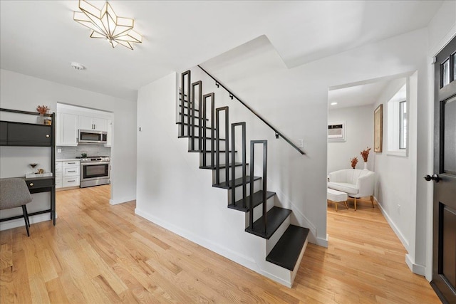 56 Summers St, Oyster Bay, NY 11771 - stairs with wood finished floors and an AC wall unit