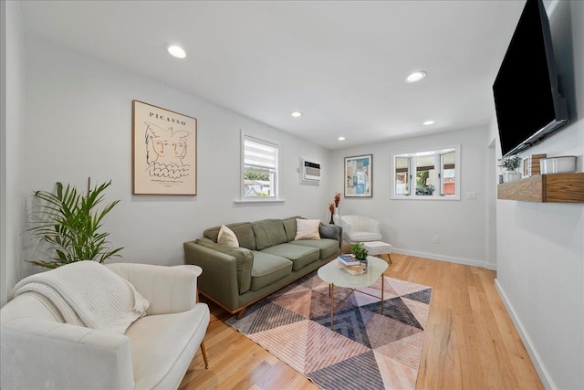 56 Summers St, Oyster Bay, NY 11771 - living area featuring light wood finished floors, an AC wall unit, and recessed lighting