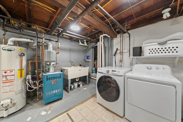 56 Summers St, Oyster Bay, NY 11771 - laundry room featuring gas water heater, washer and dryer, a heating unit, and tile patterned floors