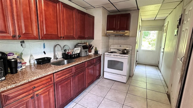 16 Upper Ferndale Rd, Liberty, NY 12754 - kitchen with electric range, under cabinet range hood, reddish brown cabinets, and a drop ceiling