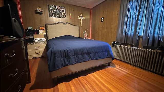 16 Upper Ferndale Rd, Liberty, NY 12754 - bedroom featuring wooden walls, wood finished floors, and radiator heating unit
