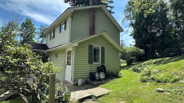 16 Upper Ferndale Rd, Liberty, NY 12754 - view of side of property with a chimney and a yard