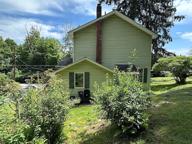 16 Upper Ferndale Rd, Liberty, NY 12754 - view of property exterior with a chimney and a lawn