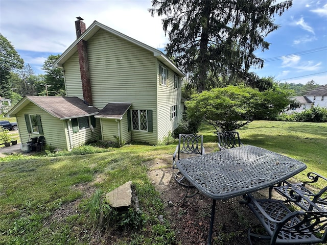 16 Upper Ferndale Rd, Liberty, NY 12754 - back of house with a chimney and a yard