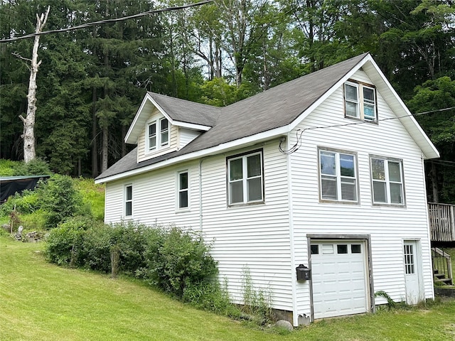 14 Upper Ferndale Rd, Liberty, NY 12754 - view of side of property featuring an attached garage, a lawn, and view of scattered trees