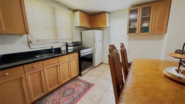 14 Upper Ferndale Rd, Liberty, NY 12754 - kitchen featuring stainless steel electric stove, freestanding refrigerator, glass insert cabinets, and light tile patterned floors