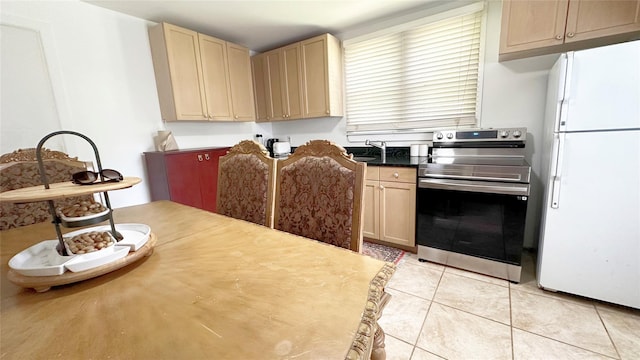14 Upper Ferndale Rd, Liberty, NY 12754 - kitchen with freestanding refrigerator, electric stove, and light tile patterned floors