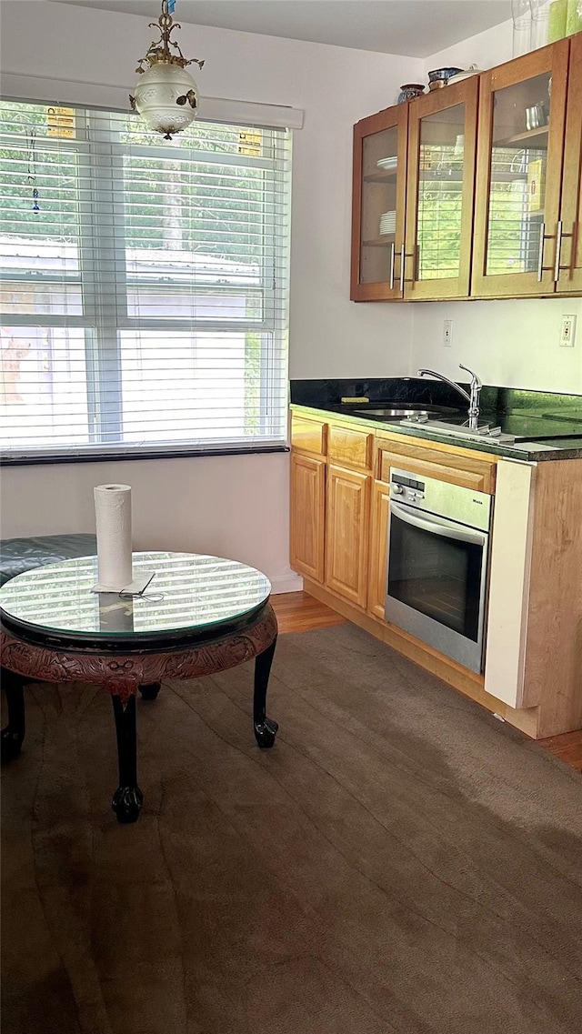 14 Upper Ferndale Rd, Liberty, NY 12754 - kitchen with oven, glass insert cabinets, dark countertops, and light wood-style flooring