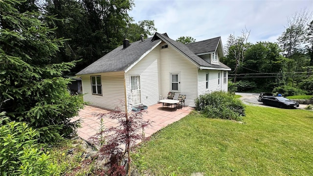 14 Upper Ferndale Rd, Liberty, NY 12754 - rear view of property with a patio area, a lawn, roof with shingles, and a chimney