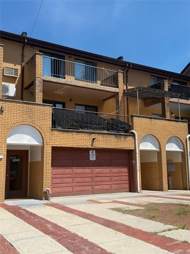 43-53 159th St, Flushing, NY 11358 - view of front of property featuring an attached garage, concrete driveway, and brick siding