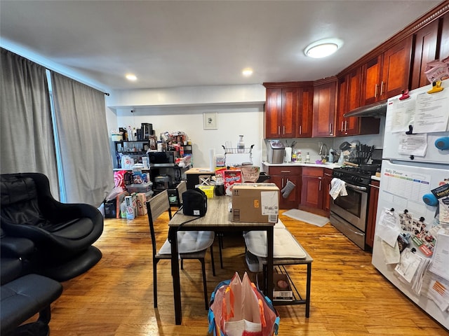 43-53 159th St, Flushing, NY 11358 - kitchen featuring freestanding refrigerator, stainless steel gas range oven, light wood finished floors, and reddish brown cabinets