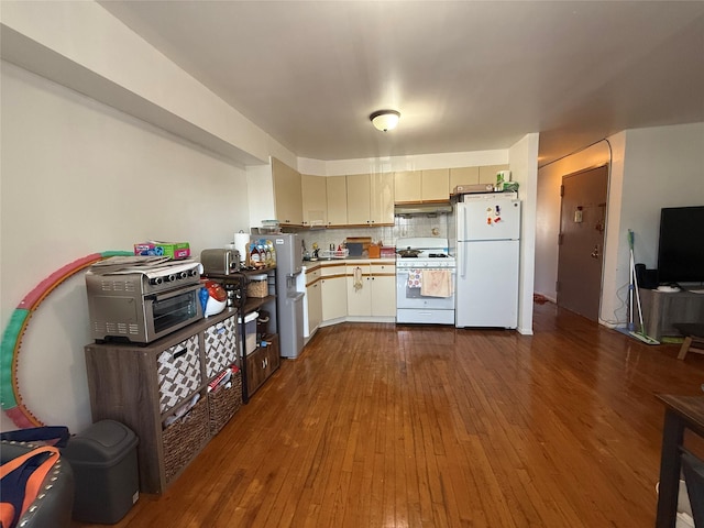 43-53 159th St, Flushing, NY 11358 - kitchen featuring white appliances, light countertops, dark wood-style floors, under cabinet range hood, and backsplash