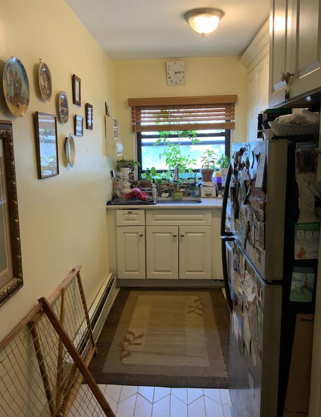 2261 Palmer Ave Unit 2A, New Rochelle, NY 10801 - kitchen featuring freestanding refrigerator, tile patterned flooring, and white cabinetry