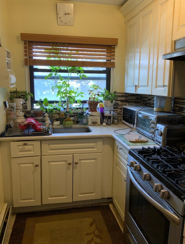 2261 Palmer Ave Unit 2A, New Rochelle, NY 10801 - kitchen featuring stainless steel range with gas cooktop, white cabinetry, exhaust hood, and light countertops