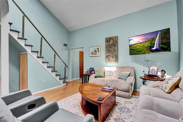 49 Primrose Ln, North Babylon, NY 11703 - living area with stairs, wood finished floors, and high vaulted ceiling
