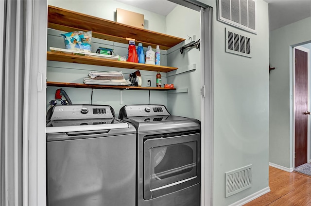 49 Primrose Ln, North Babylon, NY 11703 - laundry room with light wood-style floors and separate washer and dryer