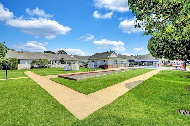 49 Primrose Ln, North Babylon, NY 11703 - surrounding community featuring a lawn, a pool, a gazebo, and a bocce ball area
