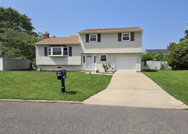 13 Lark Dr, Centereach, NY 11720 - split level home featuring a chimney, driveway, and an attached garage