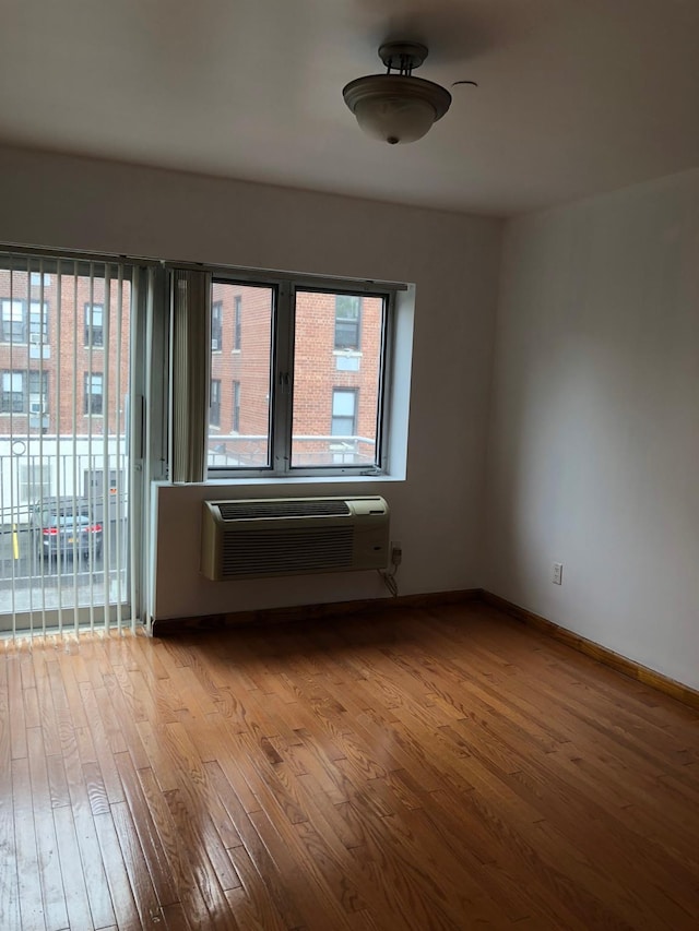 147-30 Barclay Ave Unit 3B, Flushing, NY 11355 - unfurnished room featuring wood finished floors and a wall unit AC