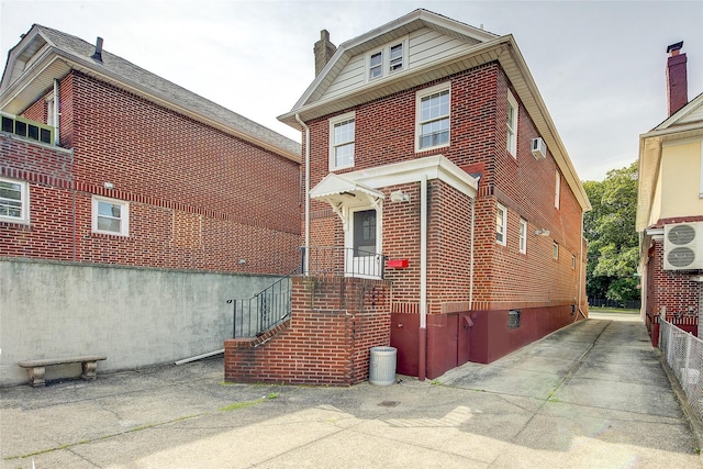 8507 Union Tpke, Glendale, NY 11385 - view of side of home featuring brick siding and a chimney