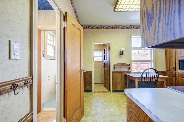 8507 Union Tpke, Glendale, NY 11385 - kitchen featuring wallpapered walls, brown cabinets, and light countertops