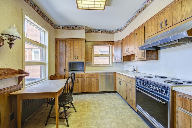 8507 Union Tpke, Glendale, NY 11385 - kitchen with black range with electric cooktop, stainless steel dishwasher, under cabinet range hood, light countertops, and brown cabinetry