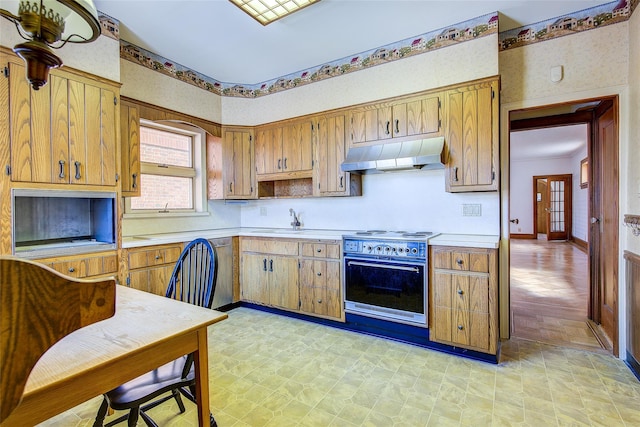 8507 Union Tpke, Glendale, NY 11385 - kitchen featuring high end range, under cabinet range hood, light countertops, and brown cabinets