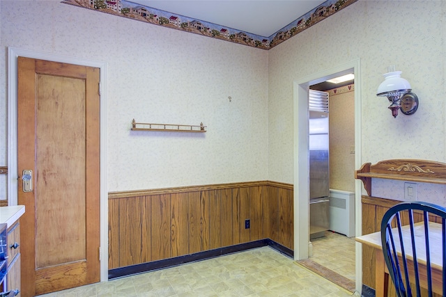 8507 Union Tpke, Glendale, NY 11385 - dining area with light floors, a wainscoted wall, wallpapered walls, and wood walls