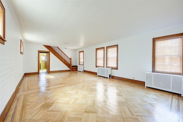 8507 Union Tpke, Glendale, NY 11385 - unfurnished living room featuring radiator and healthy amount of natural light