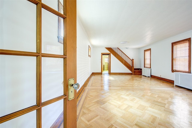 8507 Union Tpke, Glendale, NY 11385 - unfurnished living room featuring radiator heating unit, ornamental molding, and stairs