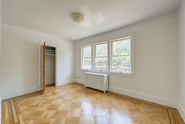 8507 Union Tpke, Glendale, NY 11385 - unfurnished bedroom featuring radiator and a closet