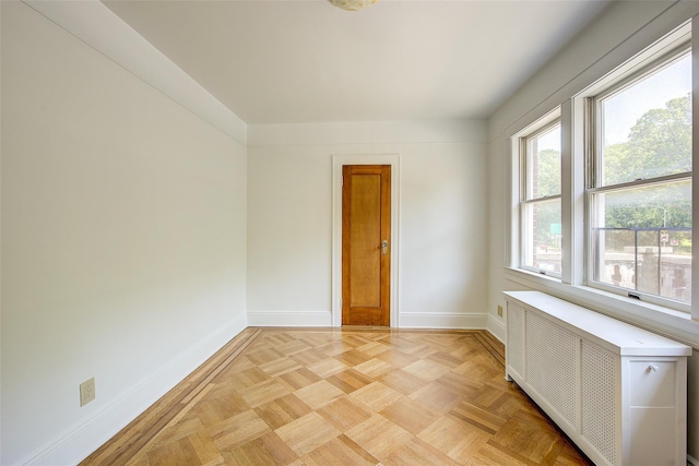 8507 Union Tpke, Glendale, NY 11385 - empty room with radiator heating unit and baseboards