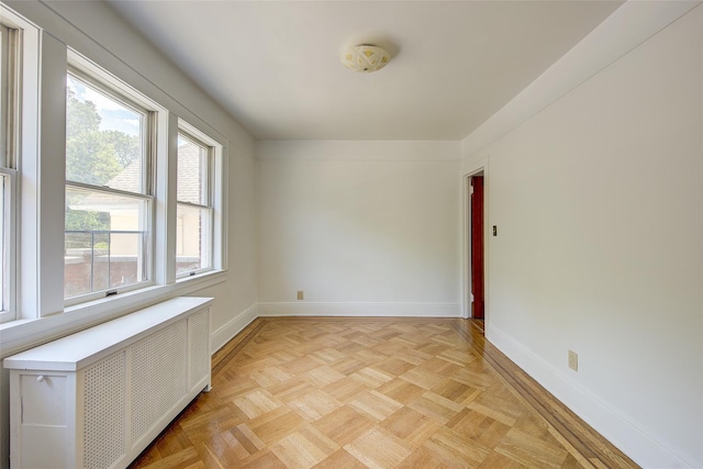 8507 Union Tpke, Glendale, NY 11385 - empty room featuring radiator and a smoke detector