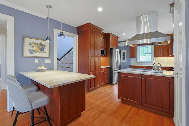 48 Faneuil Pl, New Rochelle, NY 10801 - kitchen with ventilation hood, a peninsula, appliances with stainless steel finishes, light wood-type flooring, and ornamental molding