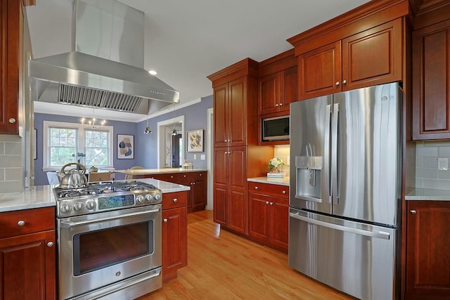 48 Faneuil Pl, New Rochelle, NY 10801 - kitchen with appliances with stainless steel finishes, wall chimney range hood, light wood-style floors, a peninsula, and light countertops