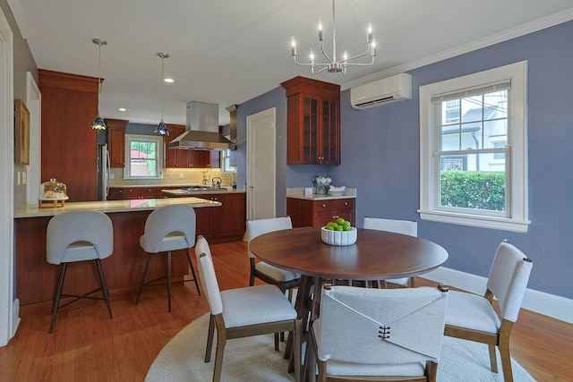 48 Faneuil Pl, New Rochelle, NY 10801 - dining room with a wall mounted air conditioner, light wood finished floors, a chandelier, crown molding, and recessed lighting