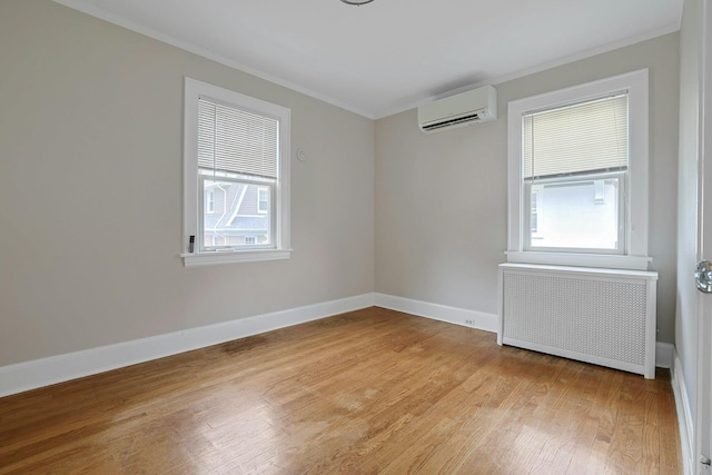 48 Faneuil Pl, New Rochelle, NY 10801 - spare room featuring radiator, a wall mounted AC, ornamental molding, healthy amount of natural light, and light wood-type flooring